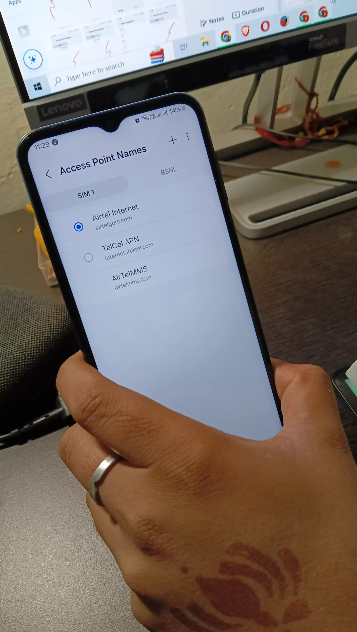 image of holding the phone with android access point name menu with telcel and airtel apn vertical